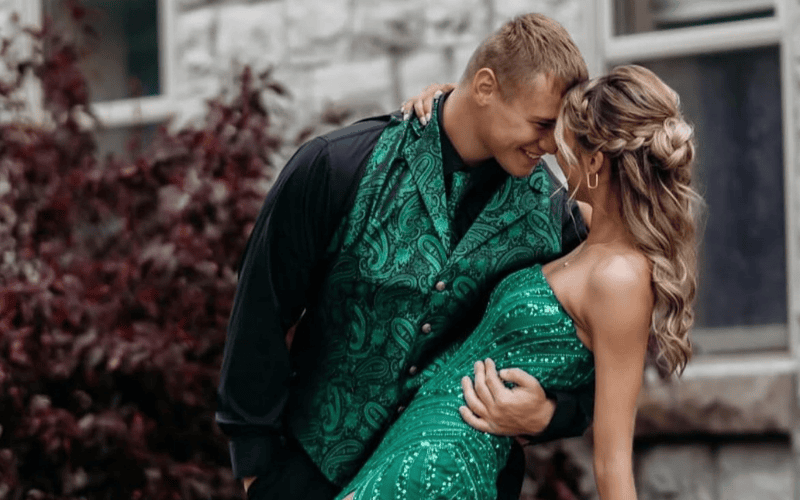 a couple wearing emerald green pair for prom 