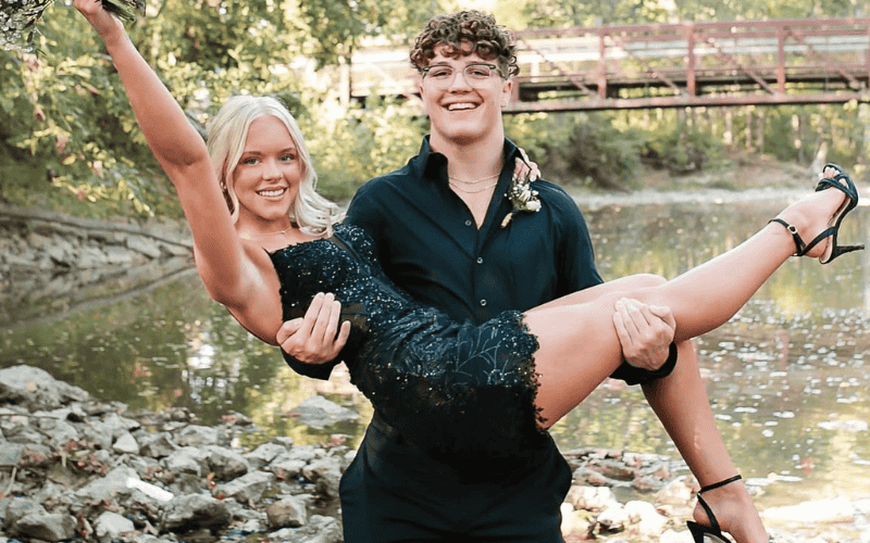 a man carrying a girl for a homecoming picture